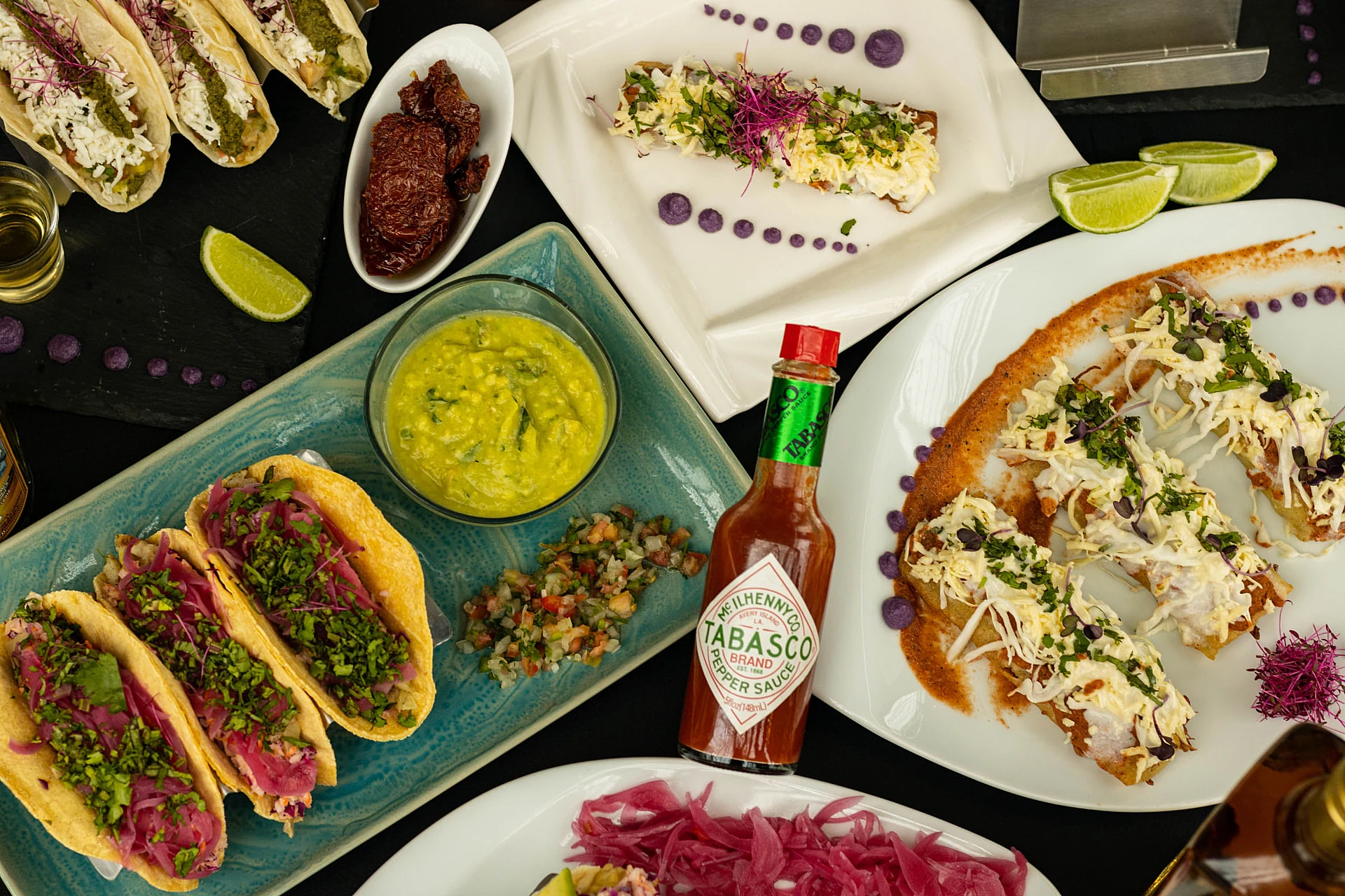 Crispy tacos, guacamole and pickled onions on a turquoise plate